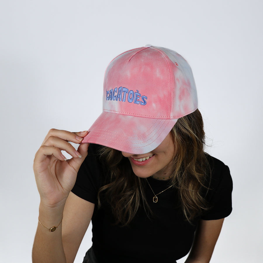 Casquette Cacottes modèle Capoeira Tie & Dye Pink Multico portée par femme : un design unique avec des couleurs tie-dye rose et multicolores, idéale pour un look estival vibrant et original.